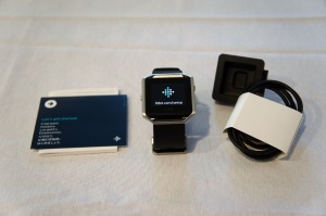Picture of the Fitbit Blaze, charging cable, and guide